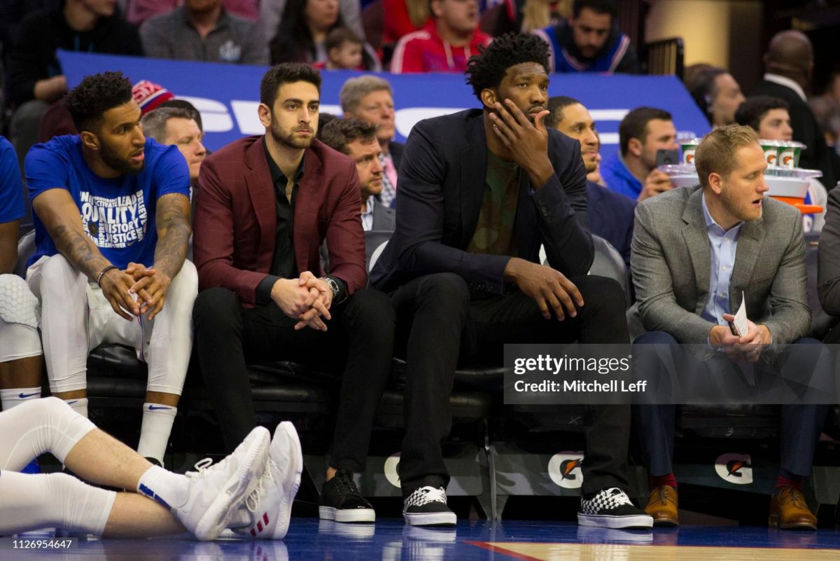 PHILADELPHIA, PA - FEBRUARY 23: Jonah Bolden #43, Furkan Korkmaz #30, and Joel Embiid #21 of the Philadelphia 76ers watch the game from the bench against the Portland Trail Blazers in the third quarter at the Wells Fargo Center on February 23, 2019 in Philadelphia, Pennsylvania. The Trail Blazers defeated the 76ers 130-115. (Photo by Mitchell Leff/Getty Images)