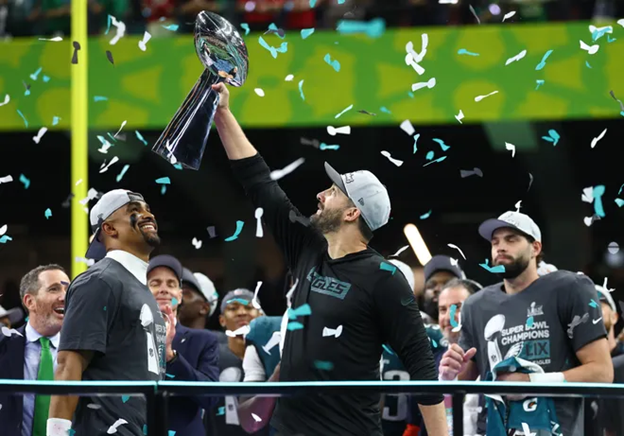 Head coach Nick Siranni holds up the Super Bowl trophy as the Eagles celebrate their victory.