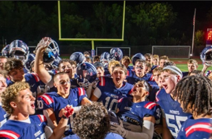 Tommy Day leads the "Rooster" chant after defeating Ridley 20-14.