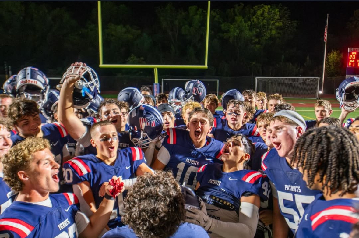 Coach Day leads the team in the "rooster" chant after defeating Ridley 20-14.